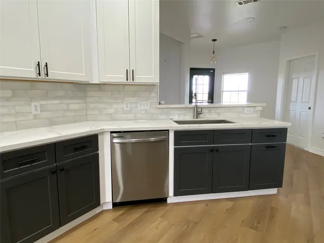 a kitchen with a sink and cabinets