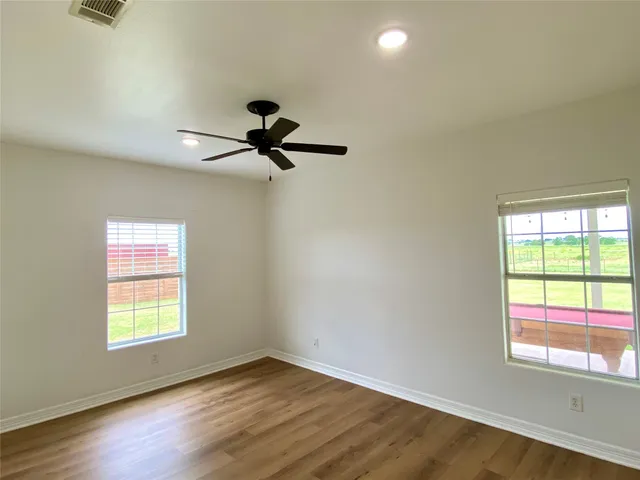 a view of a room with a window and a ceiling fan