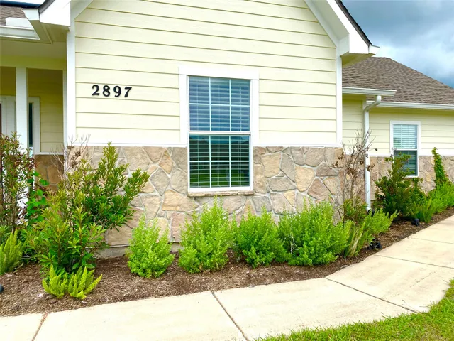 a view of a house with potted plants