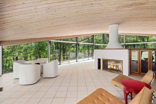 a living room with furniture and large windows