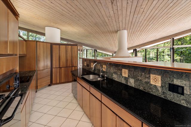 a kitchen with stainless steel appliances granite countertop a sink and a counter space