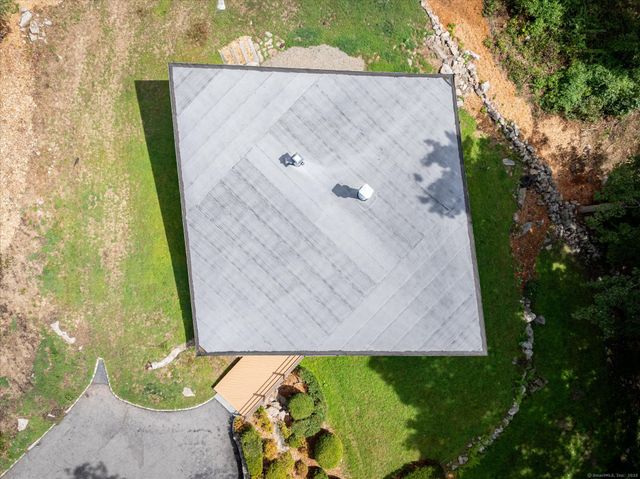 an aerial view of a house with a yard swimming pool and lake view