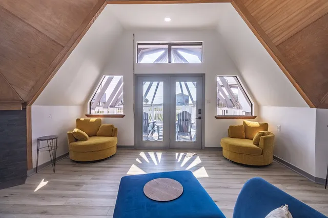 an aerial view of a ocean with residential houses with outdoor space