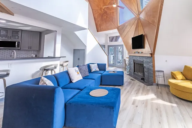 a living room with furniture fireplace and flat screen tv