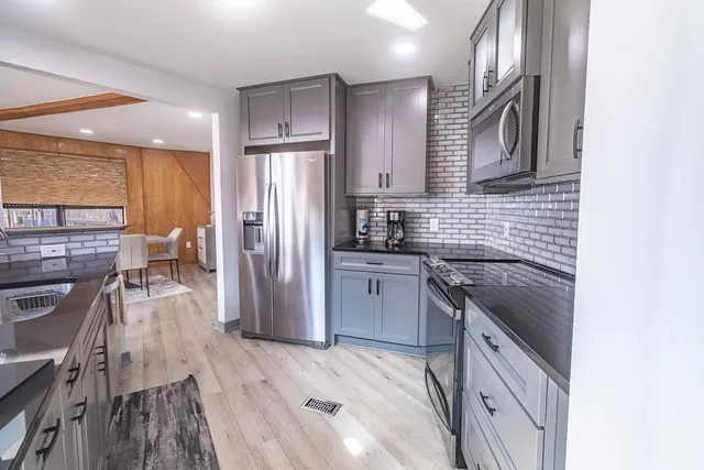 a kitchen with a sink stove and refrigerator