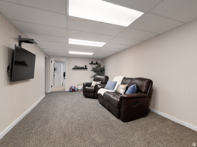 8252 Wood Street Midvale, UT 84047 - Photo 21 of 40 Spacious family room featuring neutral carpet flooring and light-toned paneled walls