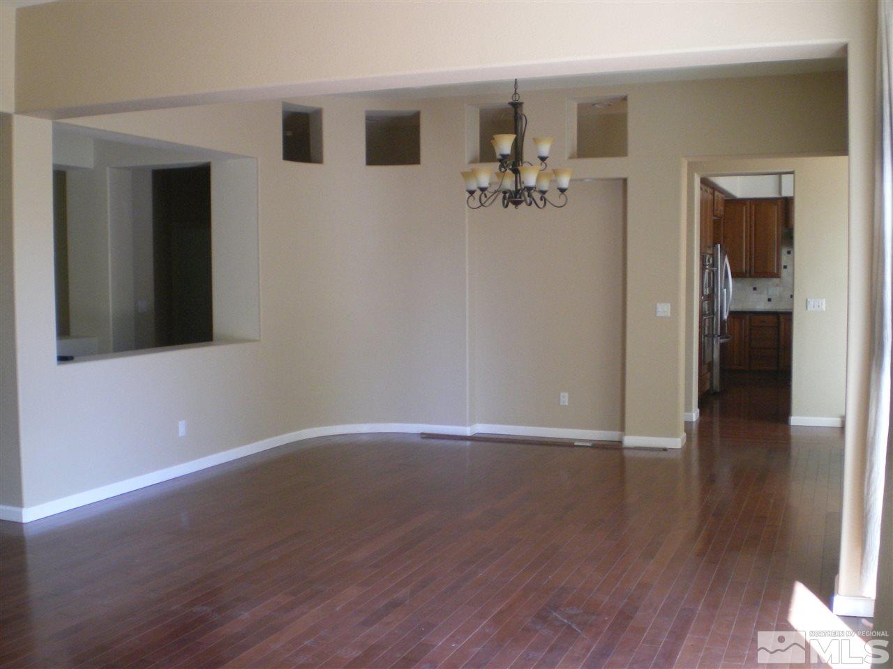 370 Flanders Road Reno, NV 89511 - Photo 14 of 25 a view of a livingroom with wooden floor and a bathroom