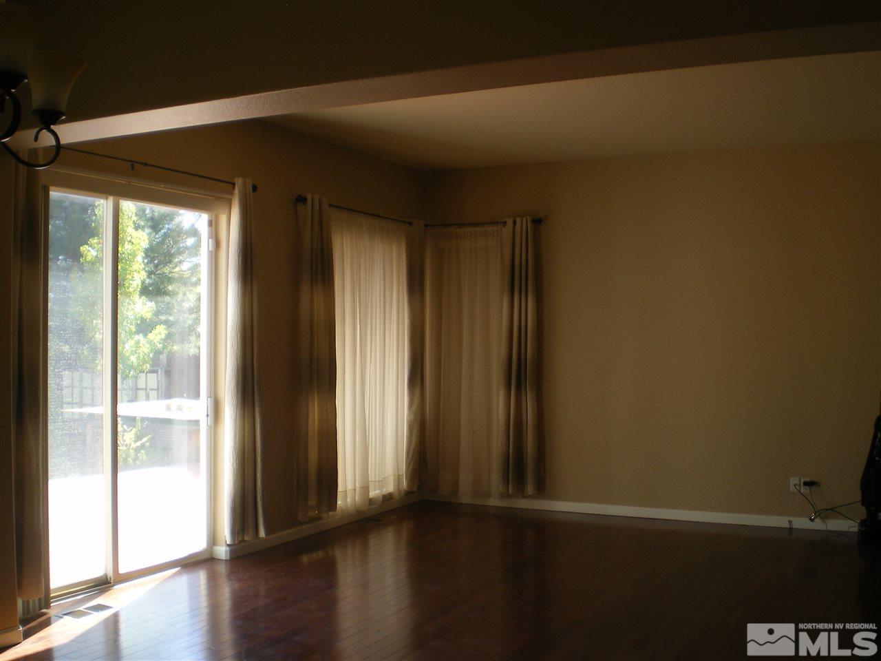 370 Flanders Road Reno, NV 89511 - Photo 15 of 25 a view of empty room with wooden floor and fan