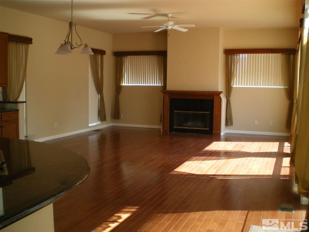 370 Flanders Road Reno, NV 89511 - Photo 17 of 25 a view of a livingroom with furniture window and wooden floor