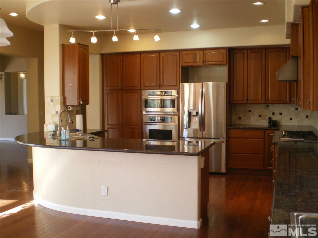 370 Flanders Road Reno, NV 89511 - Photo 20 of 25 a kitchen with stainless steel appliances granite countertop a refrigerator and a stove