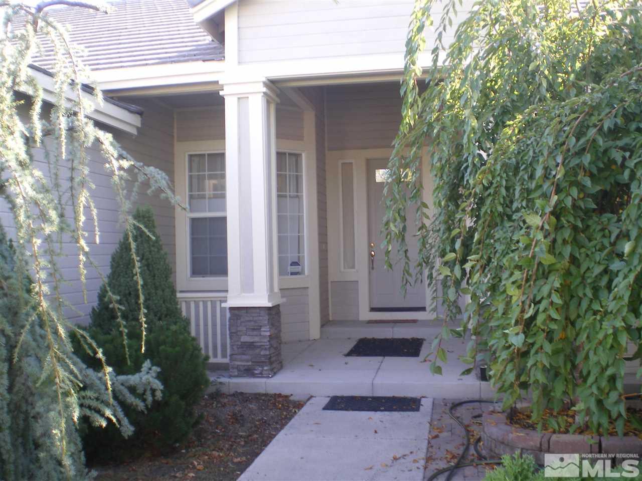 370 Flanders Road Reno, NV 89511 - Photo 2 of 25 front view of a house with a yard