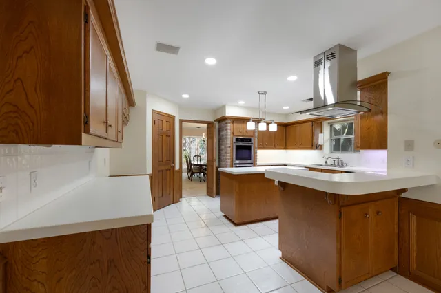 a kitchen with stainless steel appliances granite countertop a sink and a refrigerator
