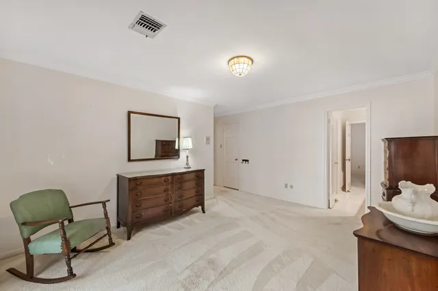 a bedroom with a bed and chair