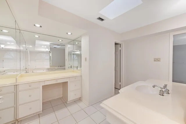 a bathroom with a sink vanity and a mirror