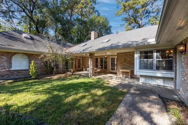a view of a house with backyard garden and sitting area