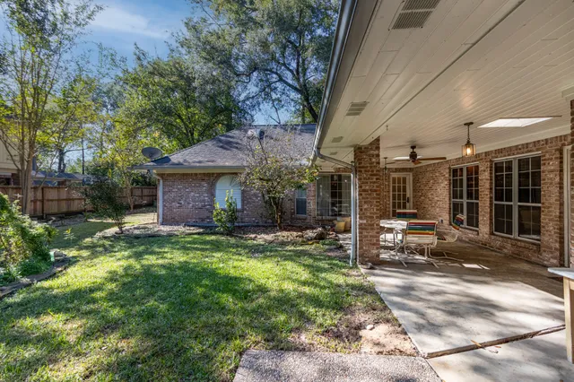 a view of a house with backyard porch and sitting area
