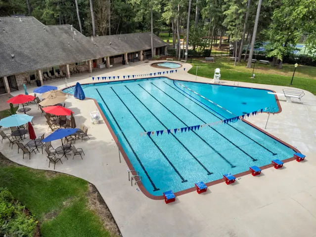 an aerial view of a house with swimming pool patio and outdoor seating