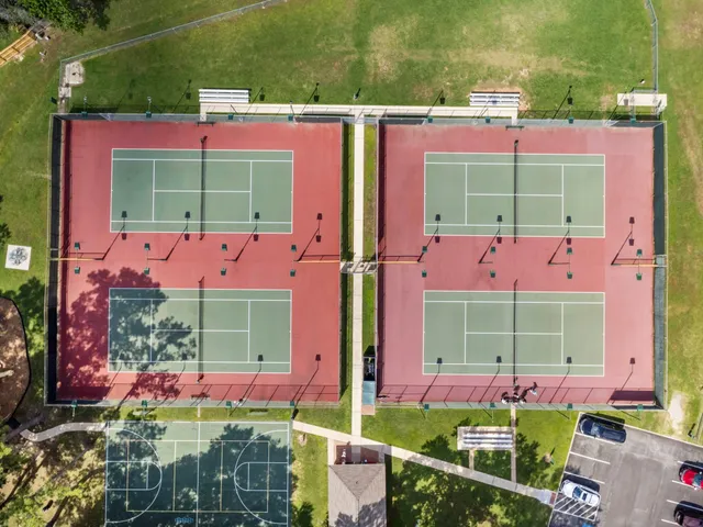 an outdoor space with lots of trees and buildings