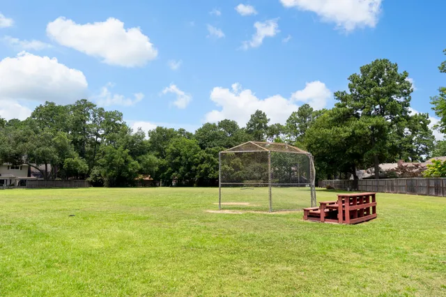 a view of a house with a backyard and a garden