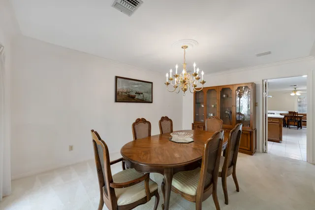 a view of a dining room with furniture and chandelier