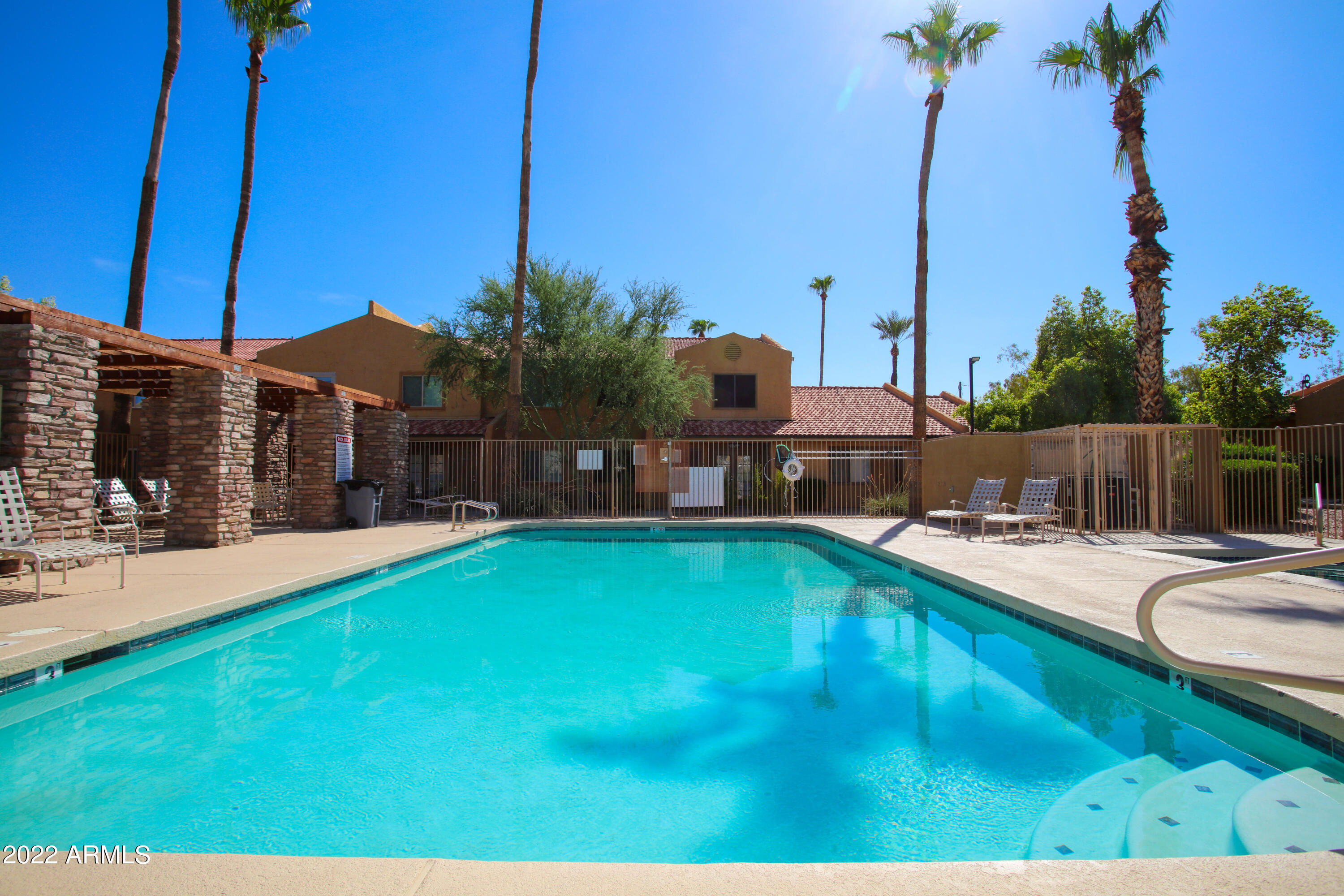 3511 East Baseline Road, Unit 1159 Phoenix, AZ 85042 - Photo 1 of 33 a swimming pool with yard and outdoor seating