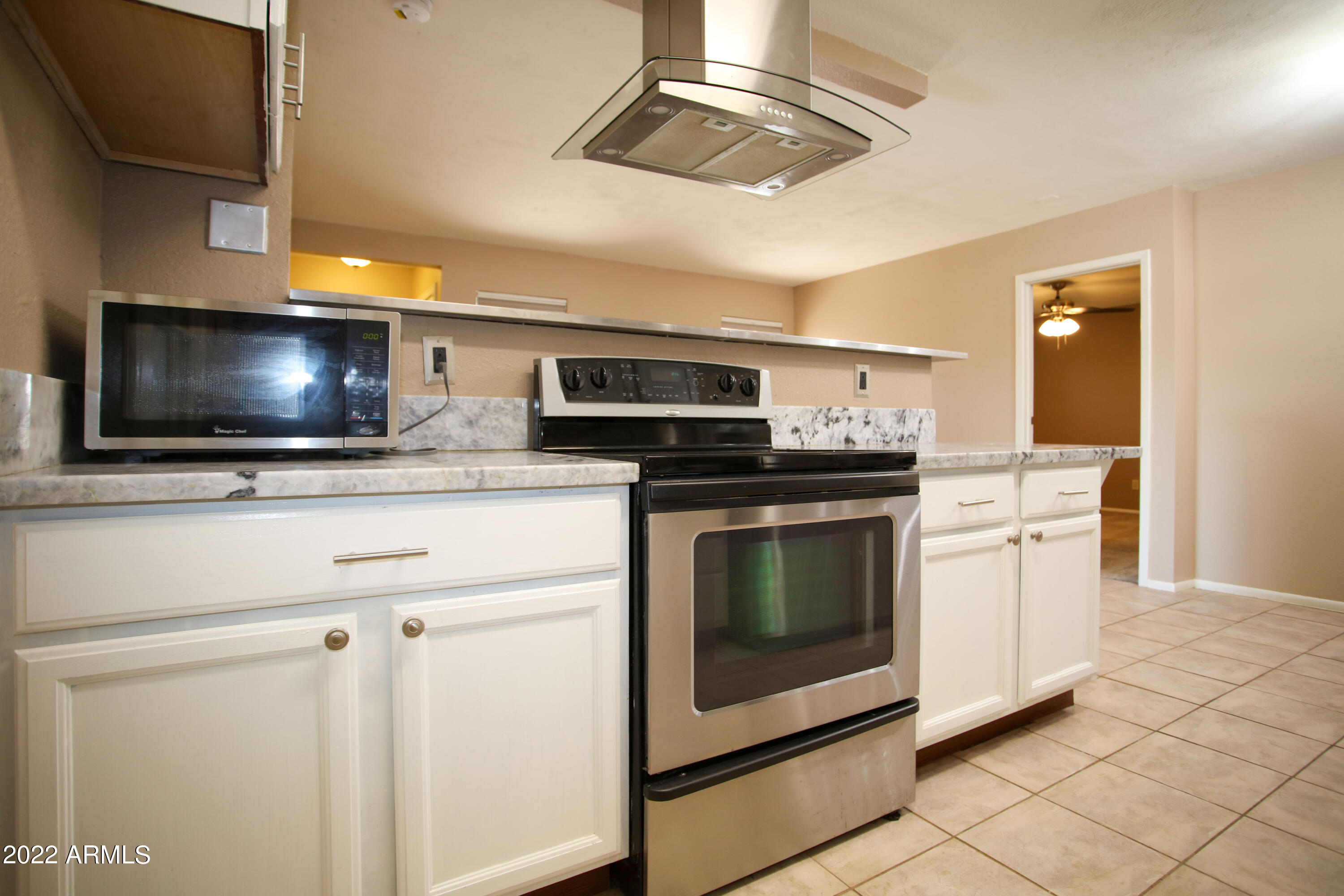 3511 East Baseline Road, Unit 1159 Phoenix, AZ 85042 - Photo 11 of 33 a kitchen with stainless steel appliances a stove microwave and cabinets