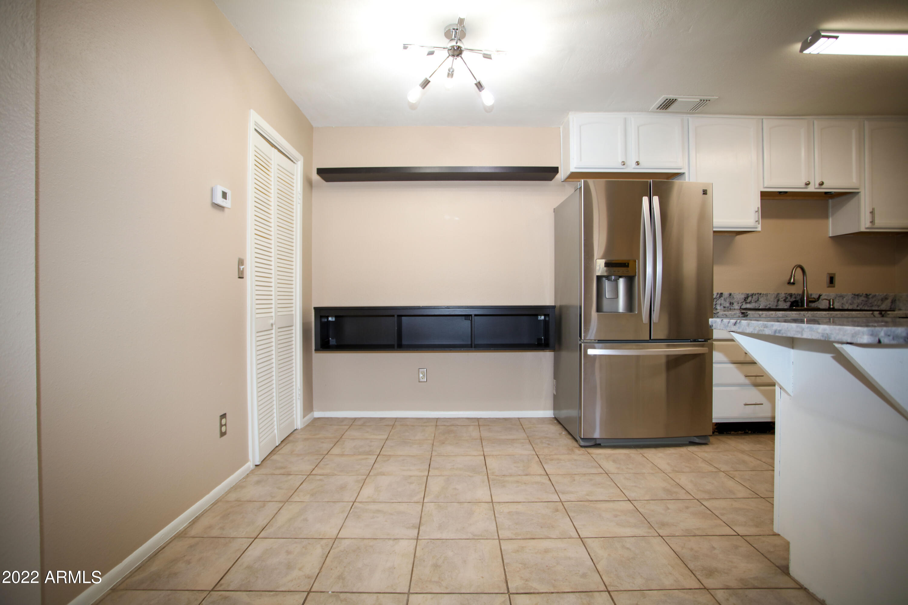 3511 East Baseline Road, Unit 1159 Phoenix, AZ 85042 - Photo 16 of 33 a kitchen with a refrigerator sink and cabinets