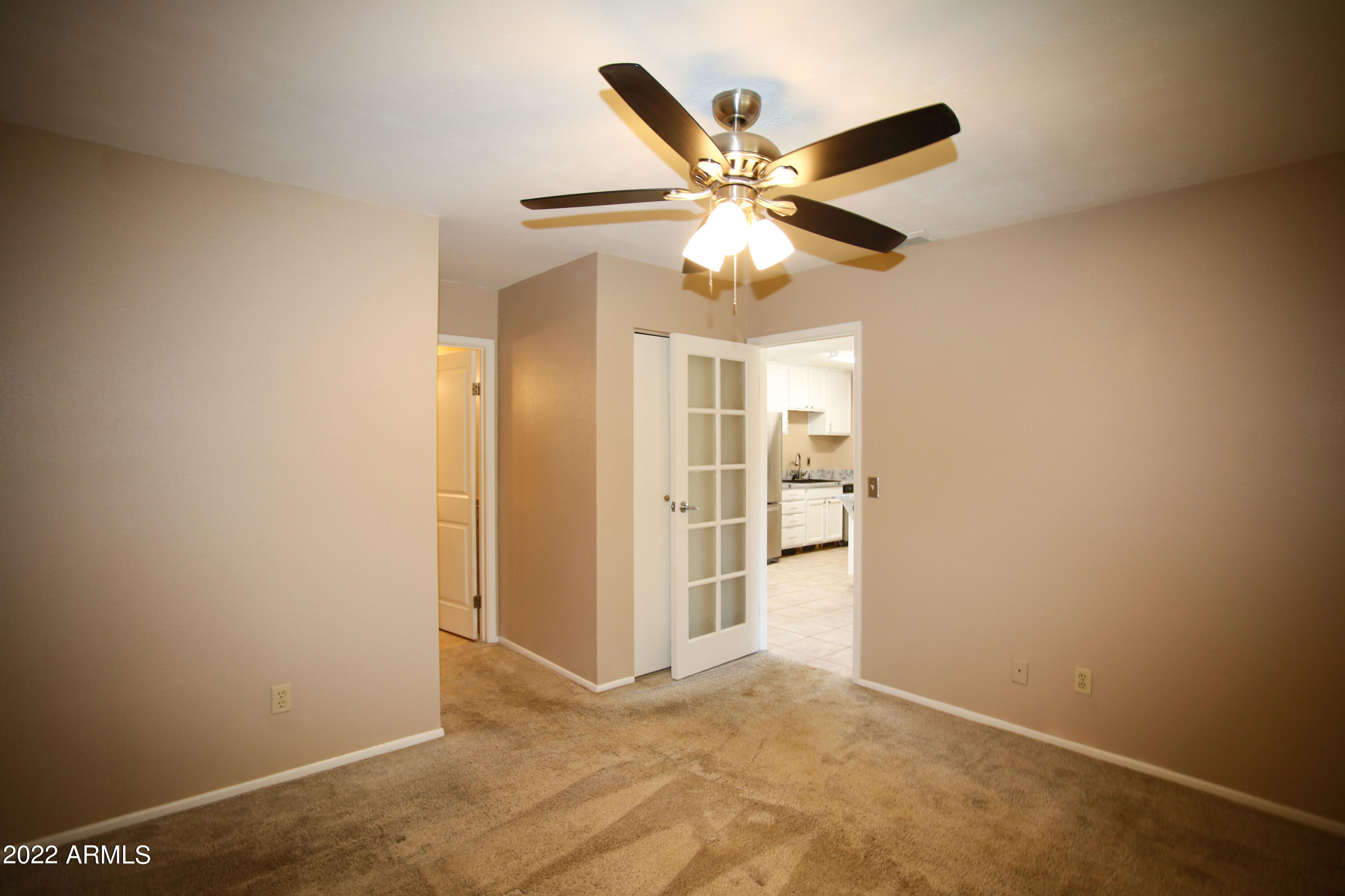 3511 East Baseline Road, Unit 1159 Phoenix, AZ 85042 - Photo 19 of 33 an empty room with windows and fan