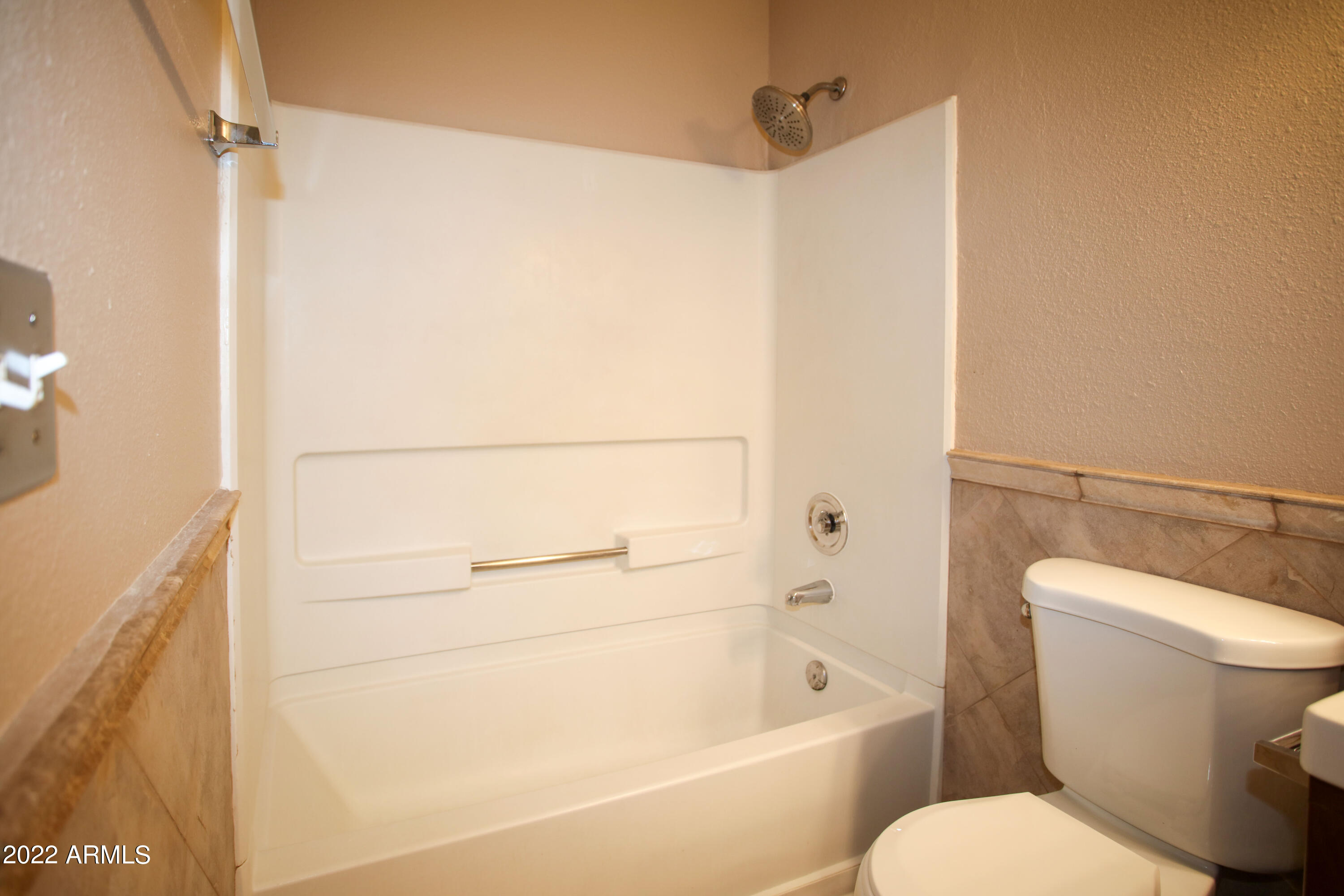 3511 East Baseline Road, Unit 1159 Phoenix, AZ 85042 - Photo 22 of 33 a bathroom with a toilet and a bathtub