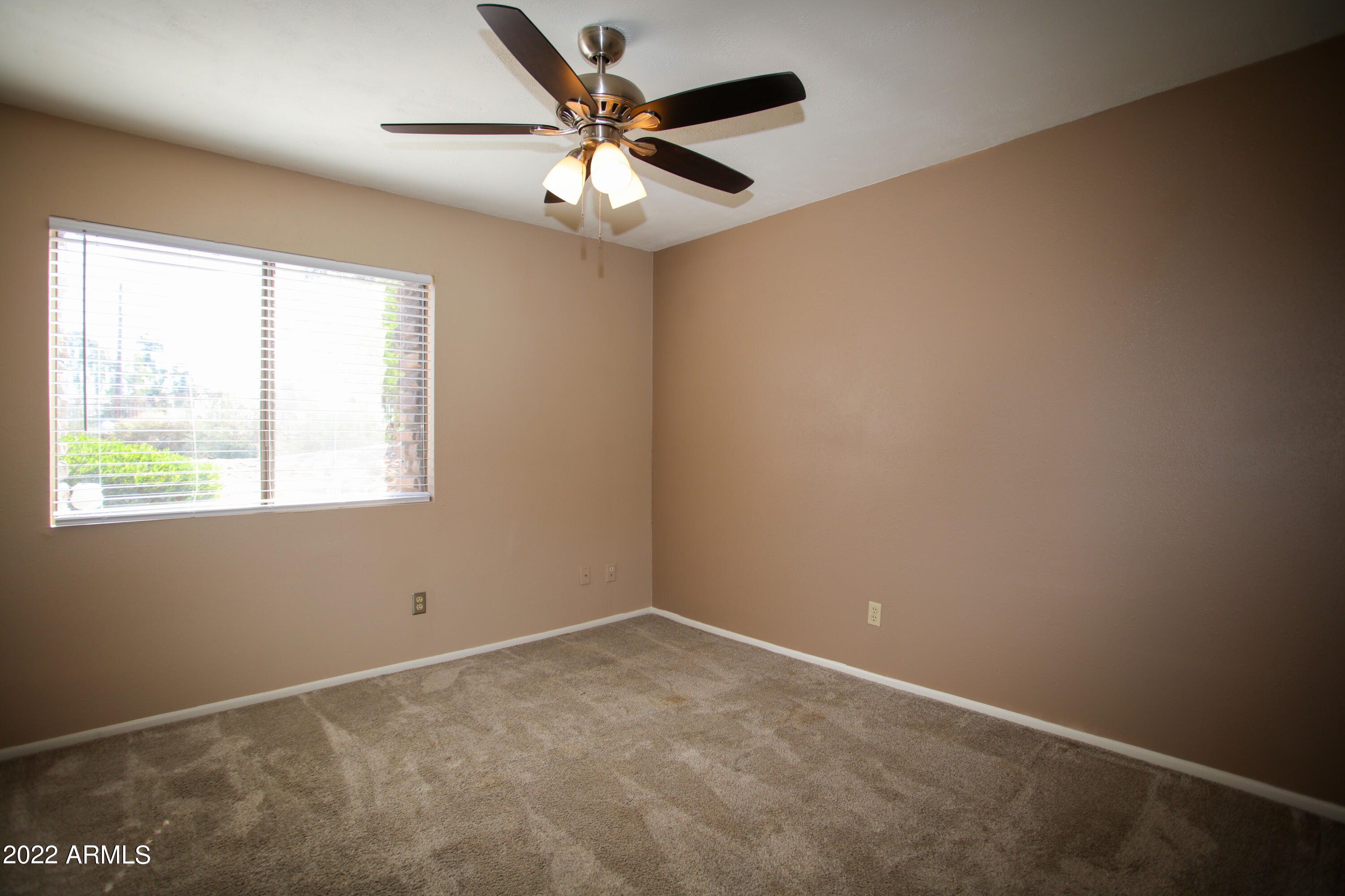 3511 East Baseline Road, Unit 1159 Phoenix, AZ 85042 - Photo 23 of 33 an empty room with a window and a fan