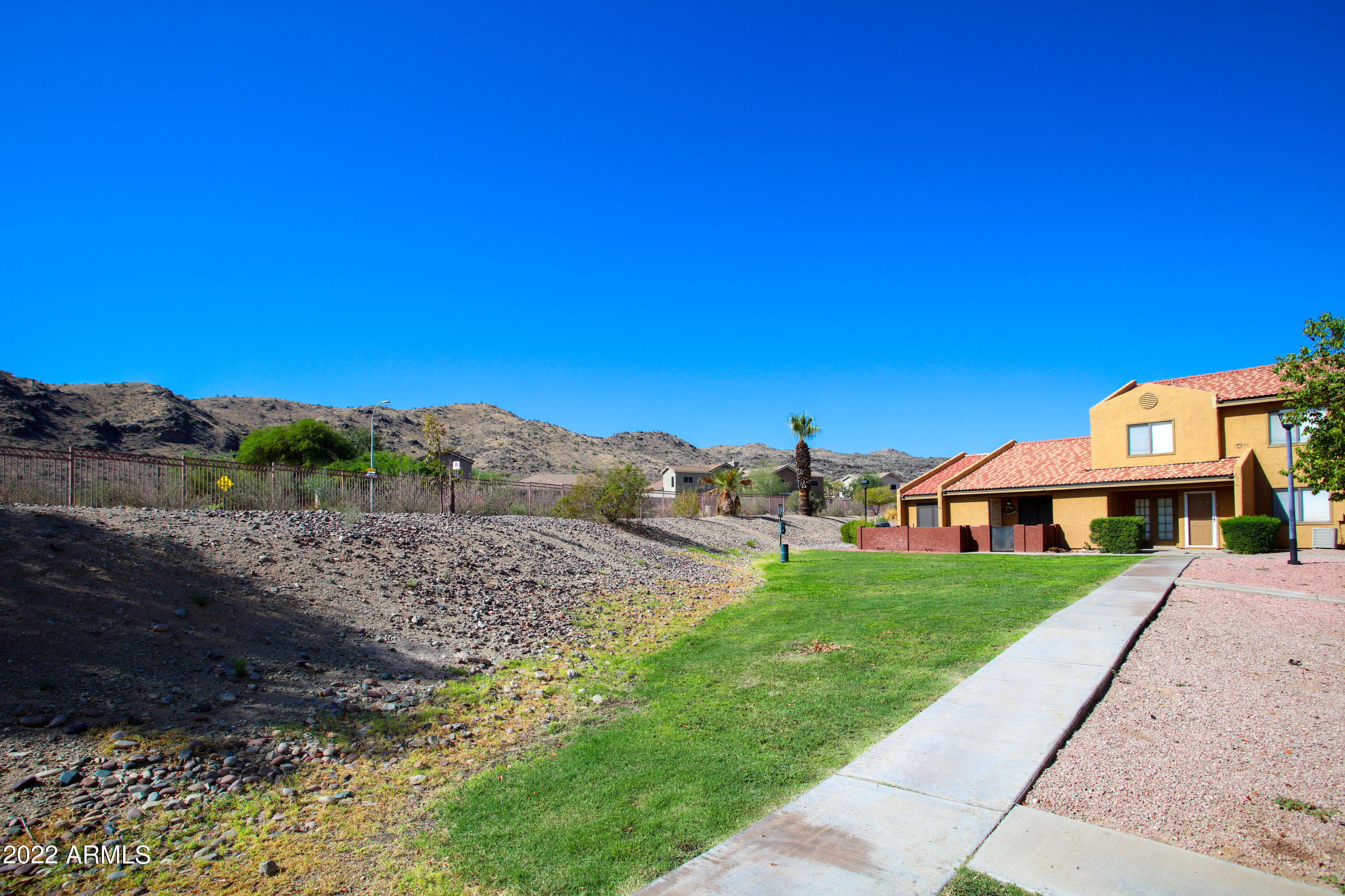 3511 East Baseline Road, Unit 1159 Phoenix, AZ 85042 - Photo 27 of 33 a front view of a house with a yard