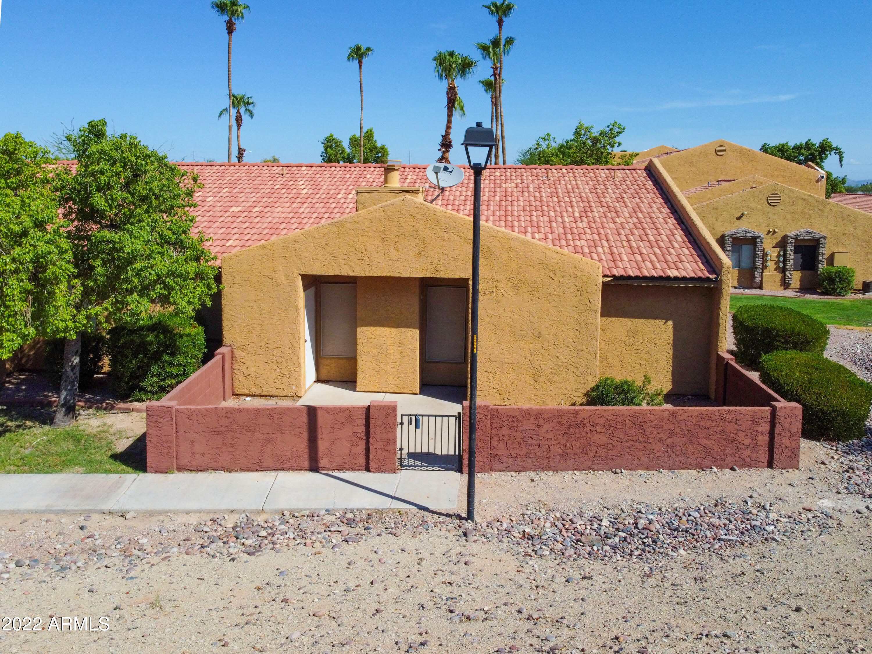 3511 East Baseline Road, Unit 1159 Phoenix, AZ 85042 - Photo 4 of 33 a front view of a house with a yard