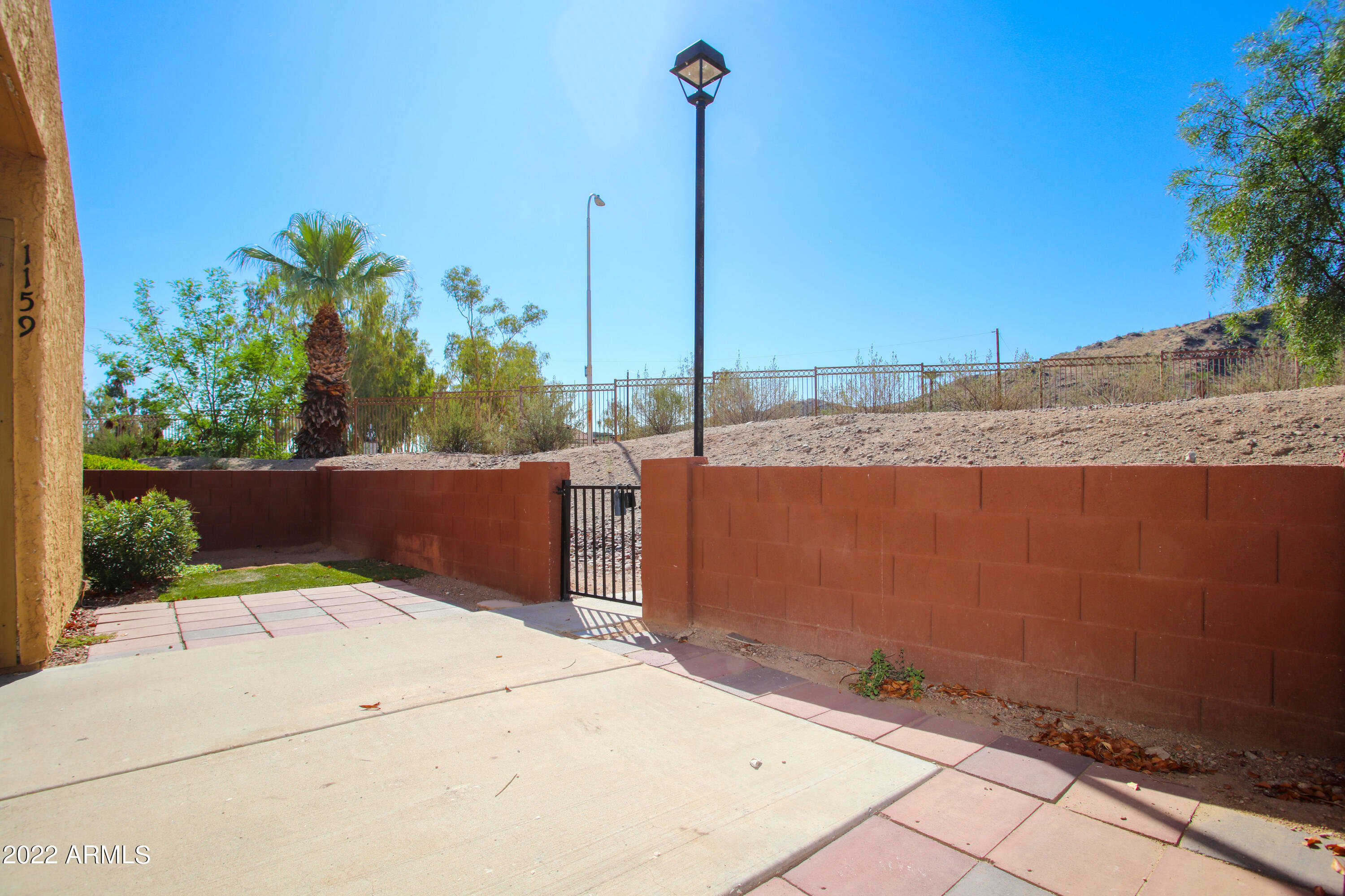 3511 East Baseline Road, Unit 1159 Phoenix, AZ 85042 - Photo 5 of 33 a view of a terrace with a bench