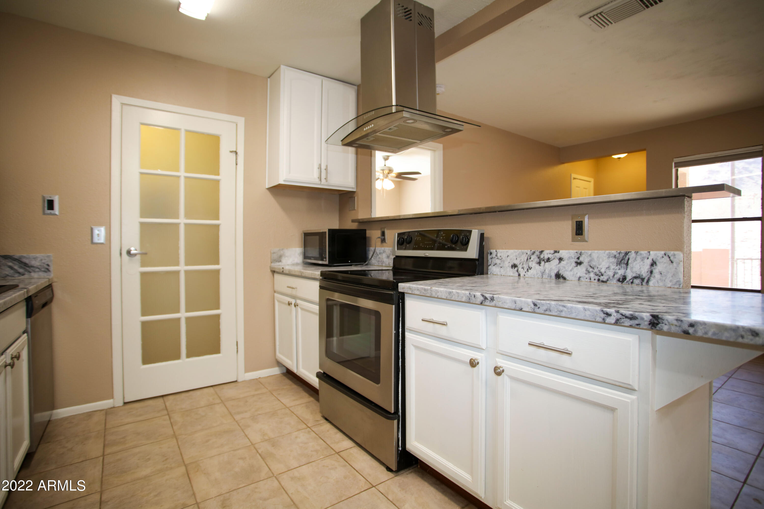 3511 East Baseline Road, Unit 1159 Phoenix, AZ 85042 - Photo 8 of 33 a kitchen with stainless steel appliances granite countertop a stove and a sink