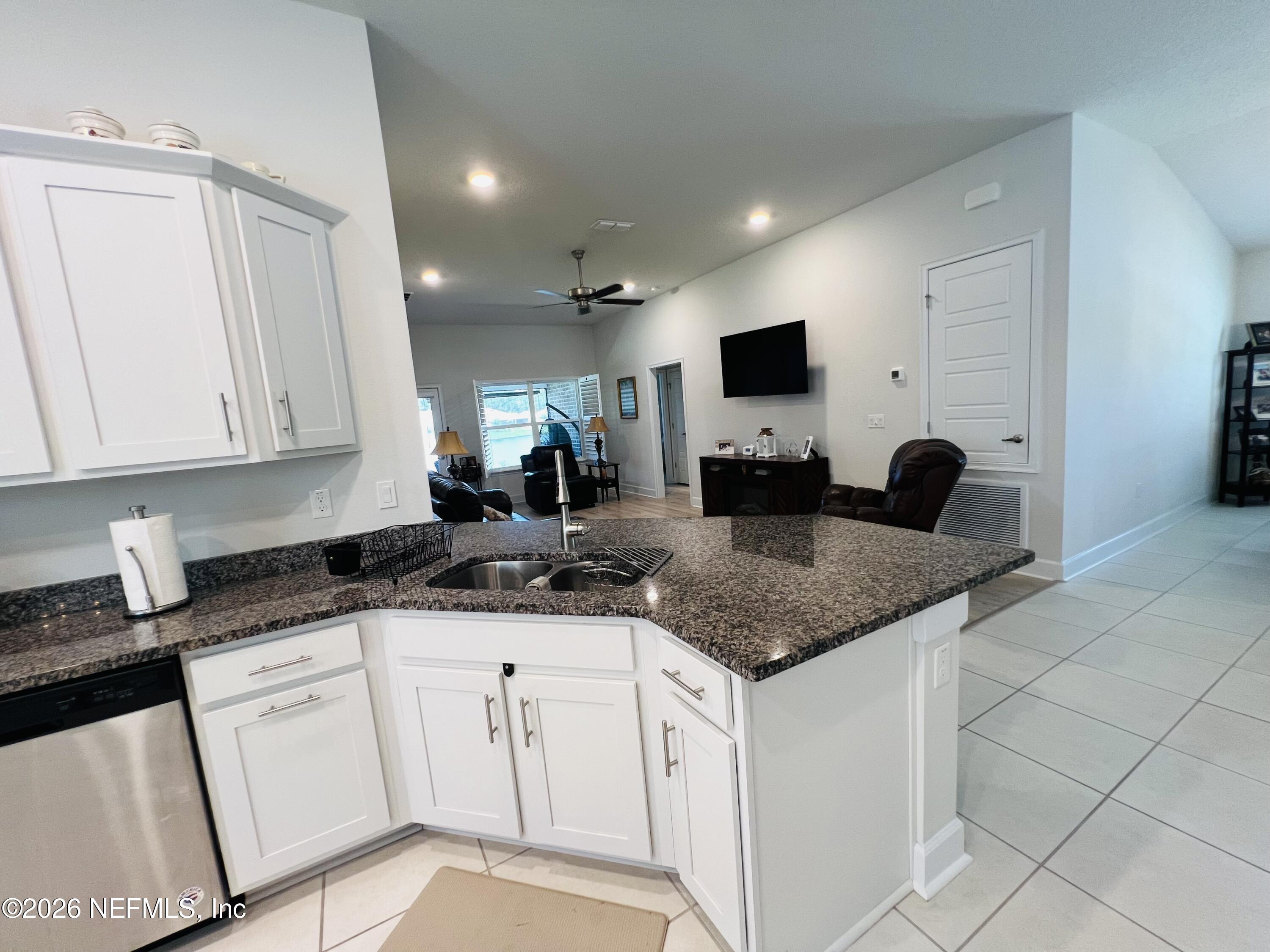 2 Rivertown Road Palm Coast, FL 32137 - Photo 35 of 80 a kitchen with granite countertop white cabinets and a granite counter tops