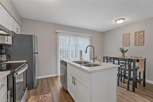 a kitchen that has a sink and a stove in it
