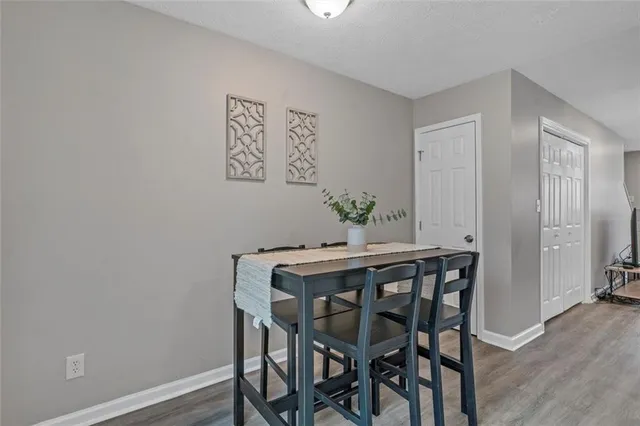 a view of a dining room with furniture and wooden floor