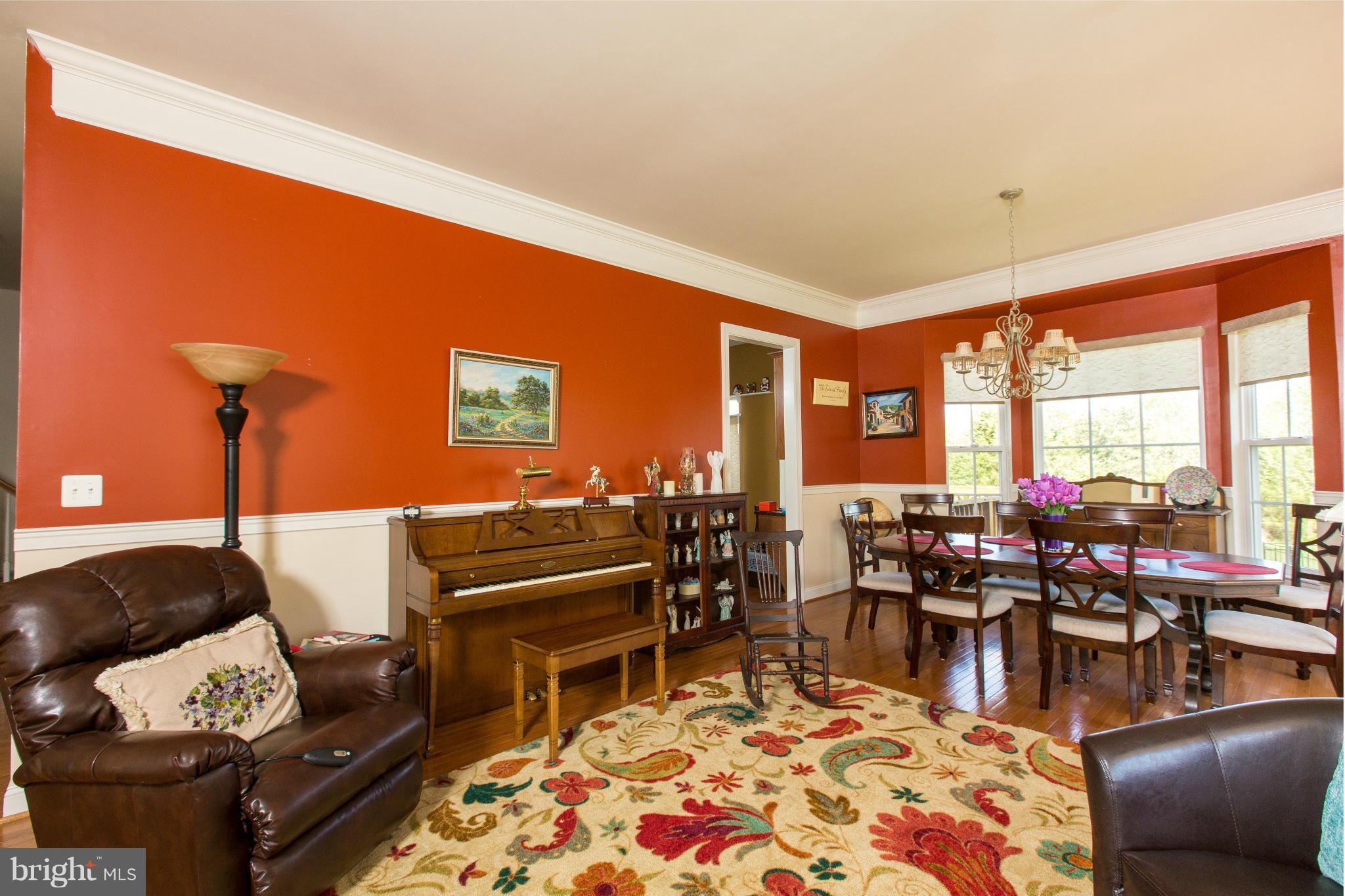 12403 Rochester Park Court Bristow, VA 20136 - Photo 11 of 30 a living room with furniture a rug and a floor to ceiling window