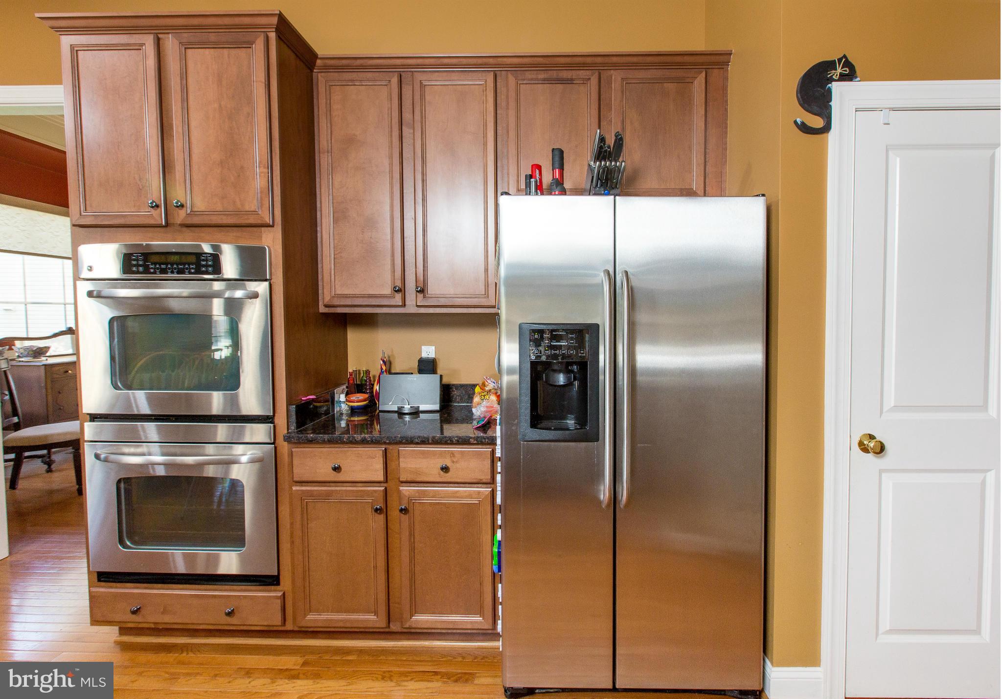 12403 Rochester Park Court Bristow, VA 20136 - Photo 13 of 30 a kitchen with granite countertop a refrigerator and a stove