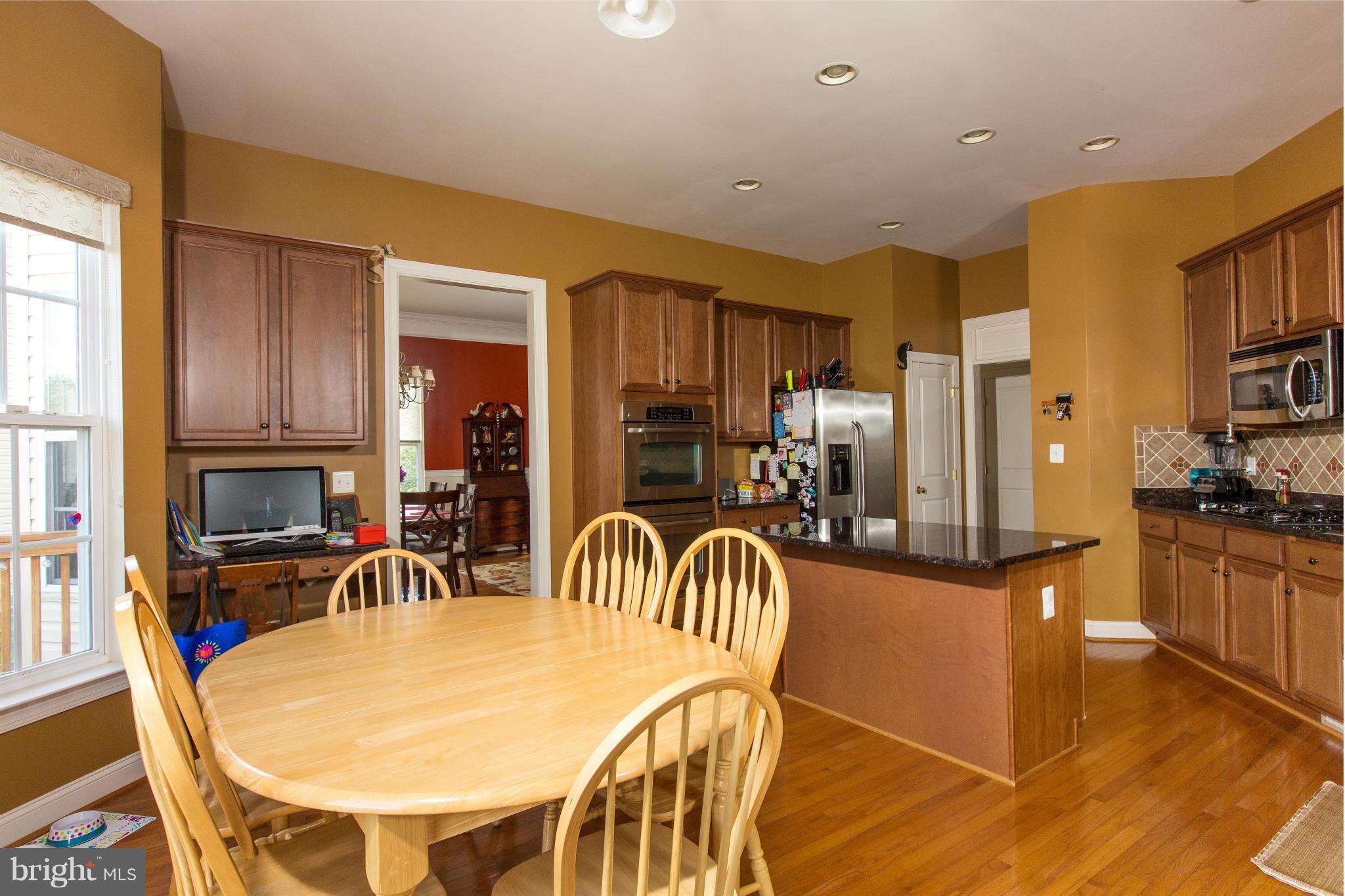 12403 Rochester Park Court Bristow, VA 20136 - Photo 15 of 30 a view of a dining room with furniture