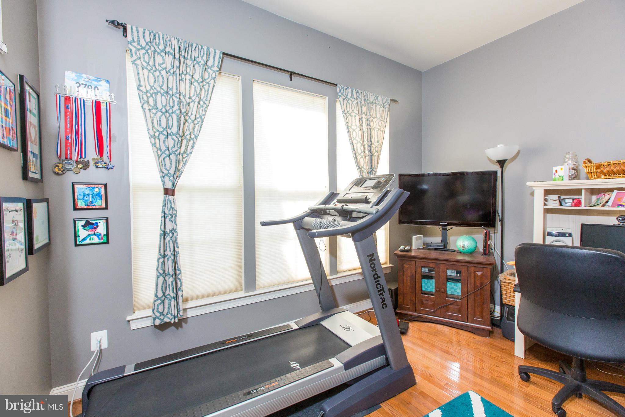 12403 Rochester Park Court Bristow, VA 20136 - Photo 18 of 30 a living room with furniture a flat screen tv and a window