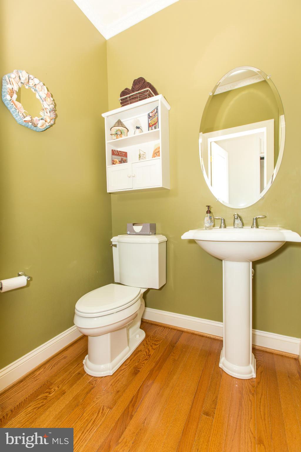 12403 Rochester Park Court Bristow, VA 20136 - Photo 19 of 30 a bathroom with a toilet sink and mirror