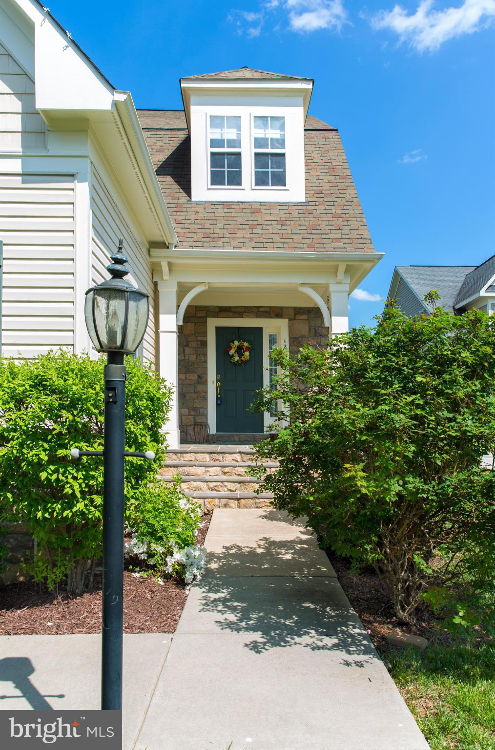 12403 Rochester Park Court Bristow, VA 20136 - Photo 3 of 30 a front view of a house with garden