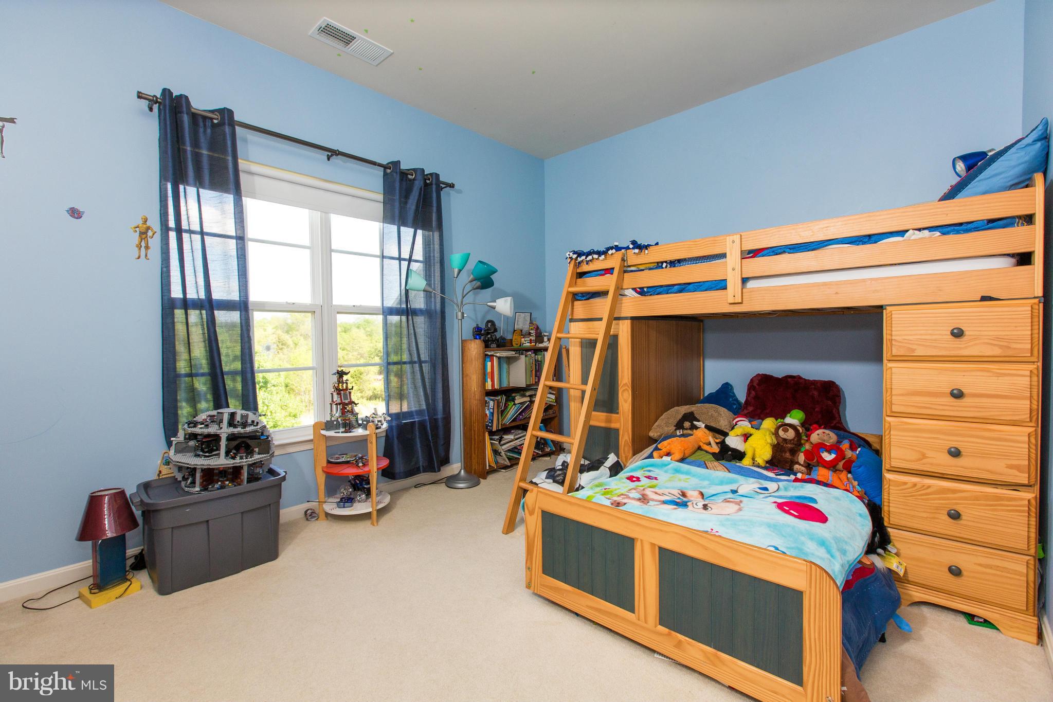 12403 Rochester Park Court Bristow, VA 20136 - Photo 23 of 30 a bedroom with a bed and a window