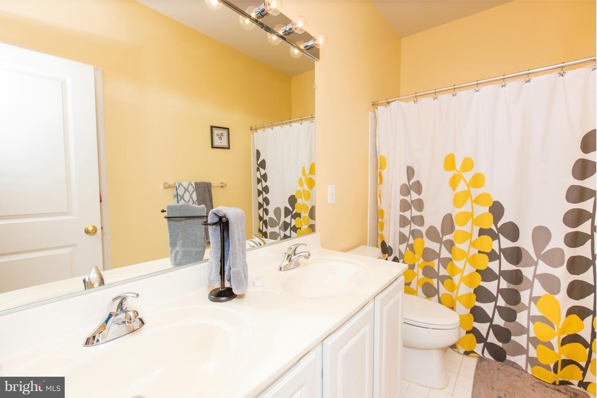 12403 Rochester Park Court Bristow, VA 20136 - Photo 24 of 30 a bathroom with a sink toilet and shower