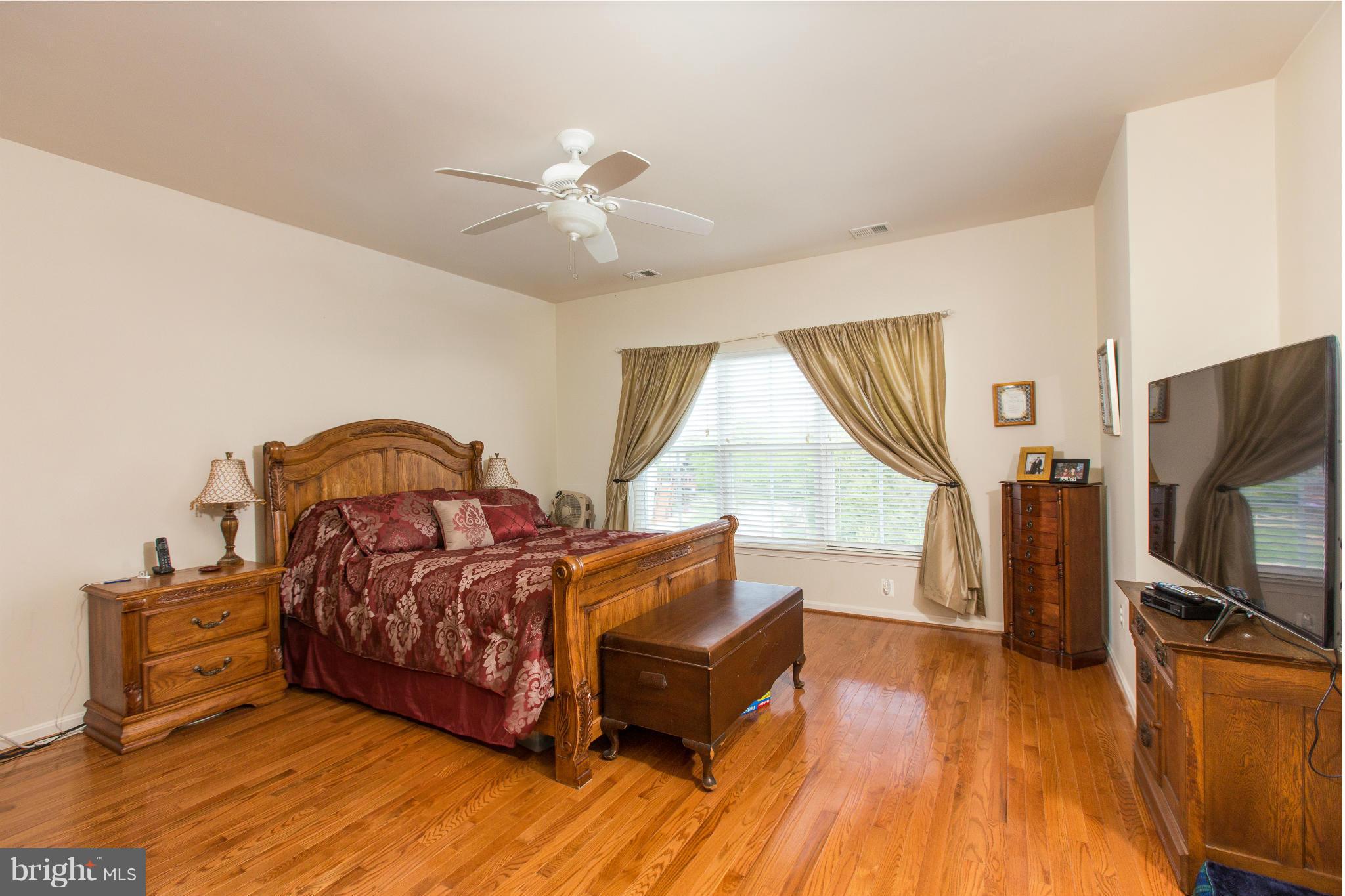 12403 Rochester Park Court Bristow, VA 20136 - Photo 26 of 30 a living room with furniture and a flat screen tv