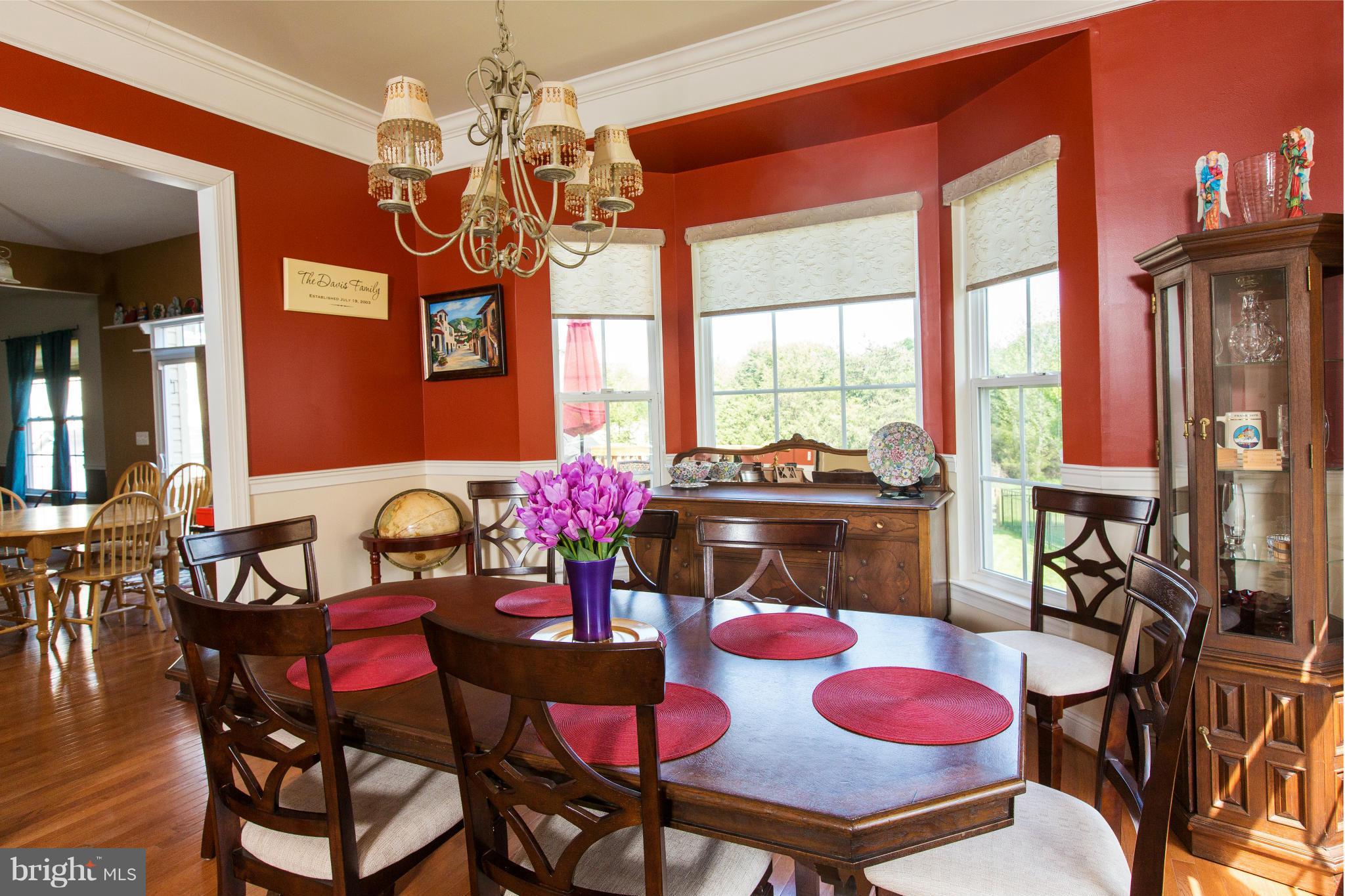 12403 Rochester Park Court Bristow, VA 20136 - Photo 6 of 30 a view of a dining room with furniture and chandelier