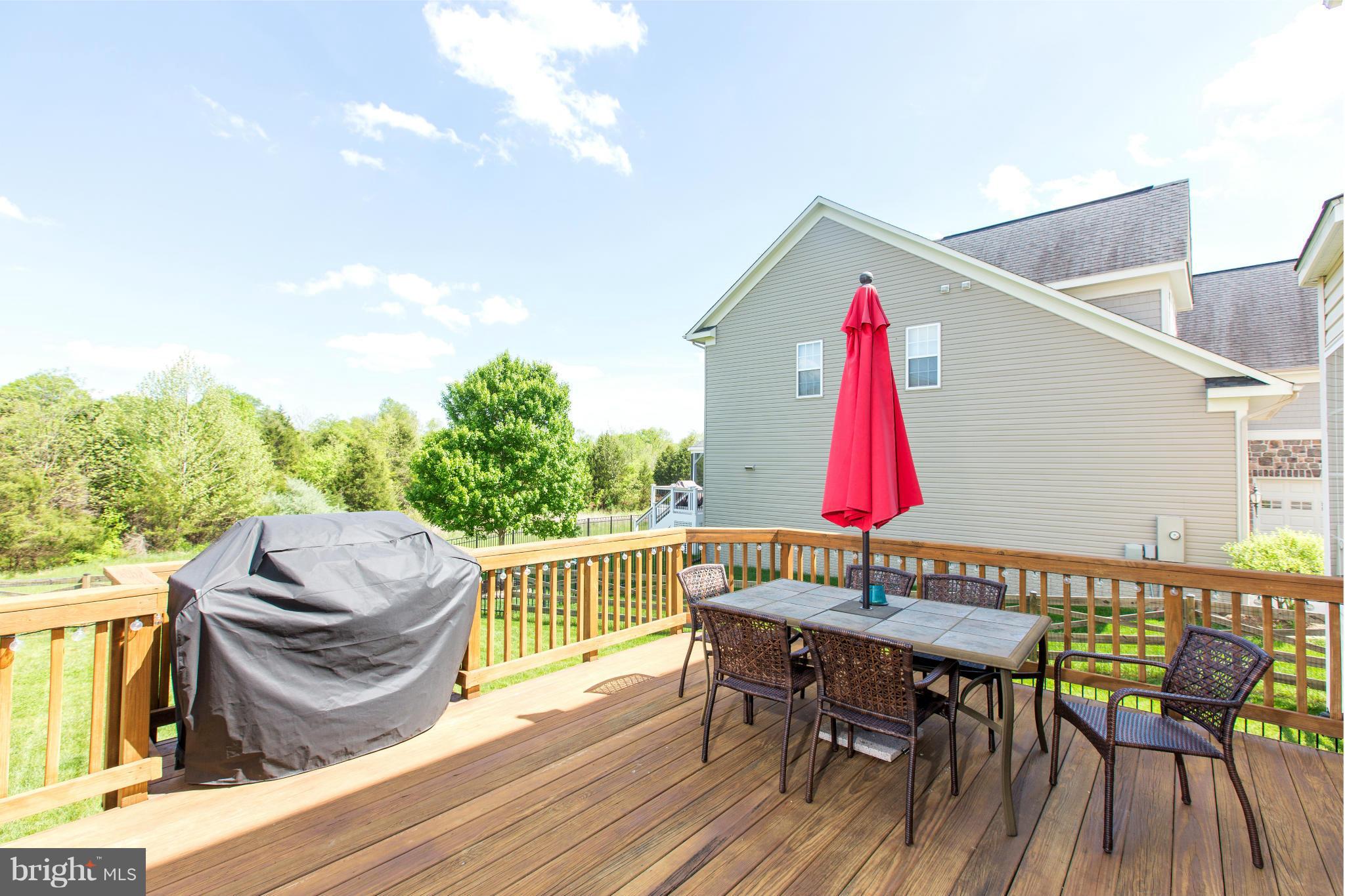 12403 Rochester Park Court Bristow, VA 20136 - Photo 8 of 30 an outdoor sitting area with furniture and wooden deck