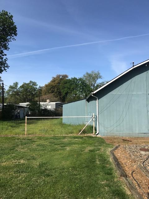 5730 Cedars Road Redding, CA 96001 - Photo 14 of 14 a backyard of a house with lots of green space