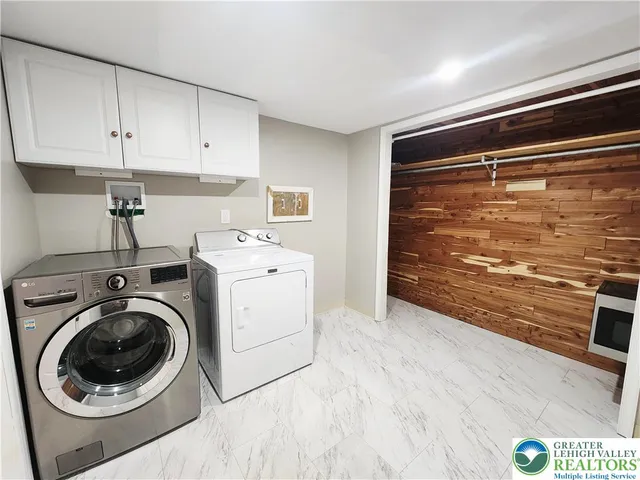 a view of a kitchen with fridge and wooden floor
